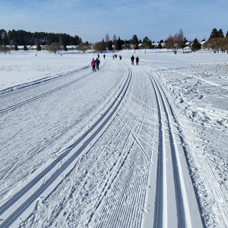 skiers on the sun slope in spring